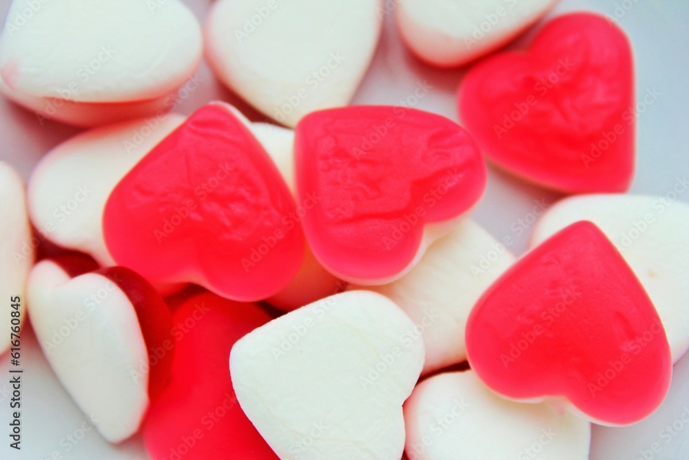 Obraz premium Pile of heart shaped jelly candies on white background
