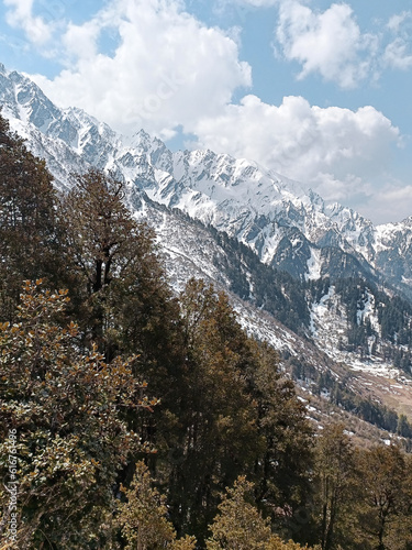 Beautiful Himalayan snow clad peaks with foliage of autumn season in Parvati Valley, India 