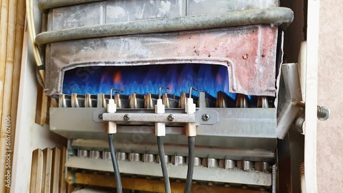 Damaged gas water heating equipment. Old gas water heater.