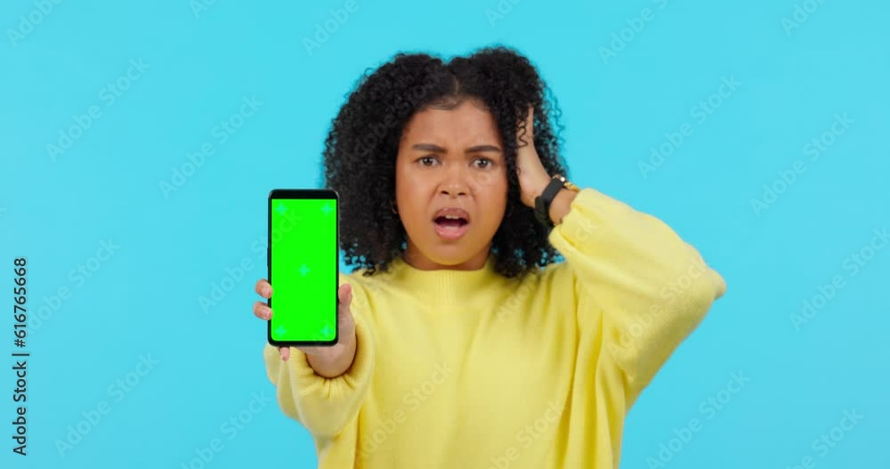 Woman, green screen phone and angry in studio with error, 404 glitch and mock up space by blue background. African student girl, smartphone or stress for slow internet, software update or fail on app Woman, green screen phone and angry in studio with error, 404 glitch and mock up space by blue background. African student girl, smartphone or stress for slow internet, software update or fail on app