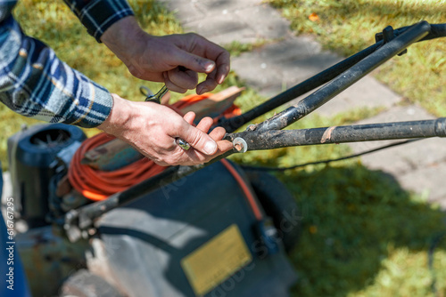 fixing broken lawnmower © vectorass