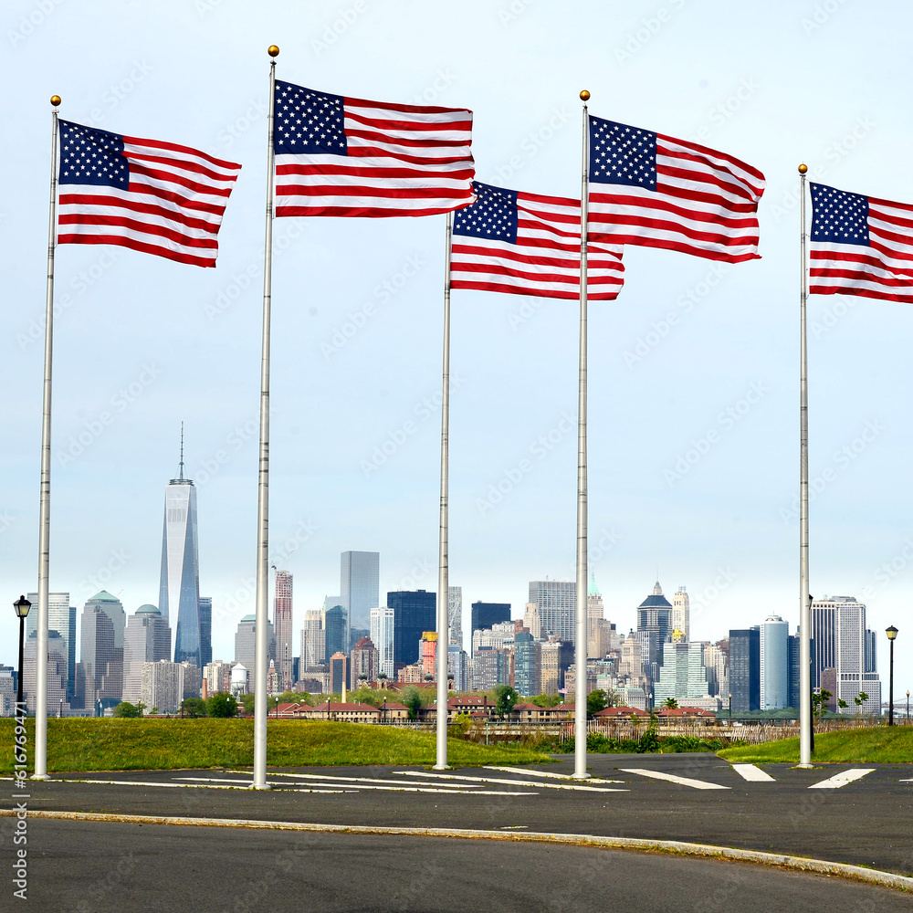 a view of Manhattan city skyline from battery park , American flags in battery park, new jersey, USA 