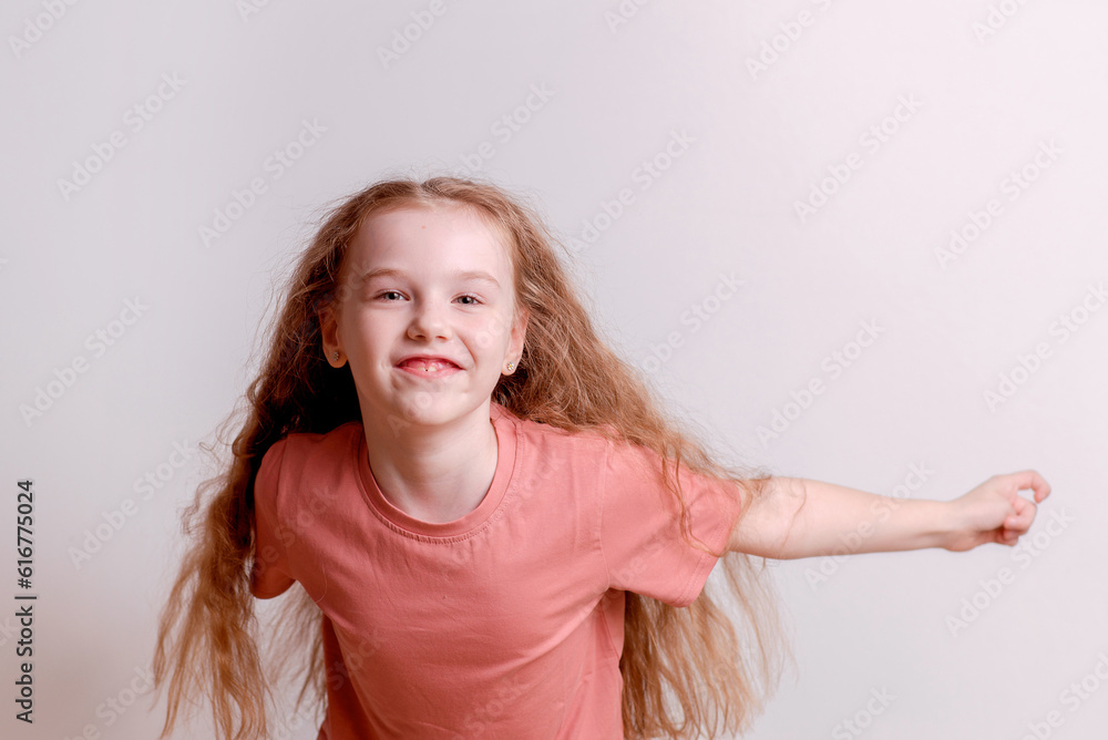 Happy and cheerful girl dancing and rejoicing on a white background Happy and cheerful girl dancing and rejoicing on a white background