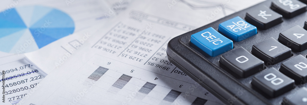 calculator and financial charts. Investment and capital accumulation concept