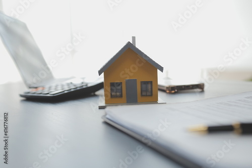 Female woman hands holding home model, small miniature white toy house. Mortgage property insurance dream moving home and real estate concept