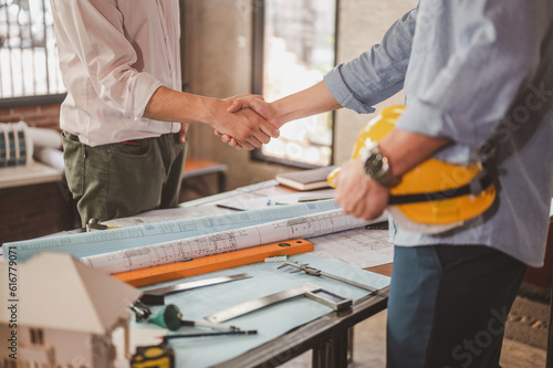 blueprint, plan, architect, project, engineer, meeting, brainstorming, teamwork, team, discussion. engineers shake hands for meet up and brainstorm to prepare blueprint architecture project builder.