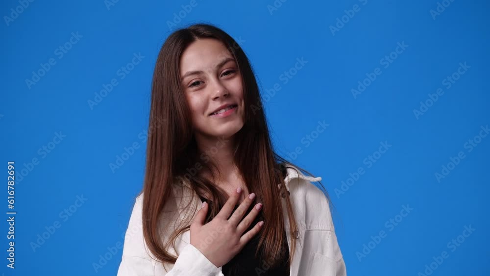 4k video of girl touching body isolated on blue background. 4k video of girl touching body isolated on blue background.