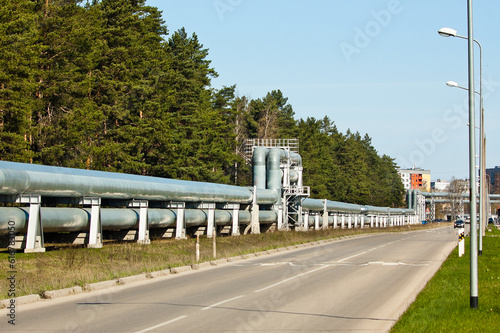 pipeline in the city, in the background of the building, forest and blue sky