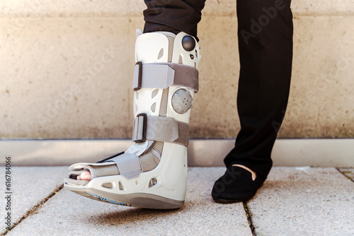 Quadro em tela Close up of the person with broken feet in grey protecting plastic boot from ank