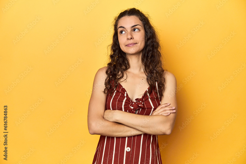 Young Caucasian woman, yellow studio background, dreaming of achieving goals and purposes Young Caucasian woman, yellow studio background, dreaming of achieving goals and purposes