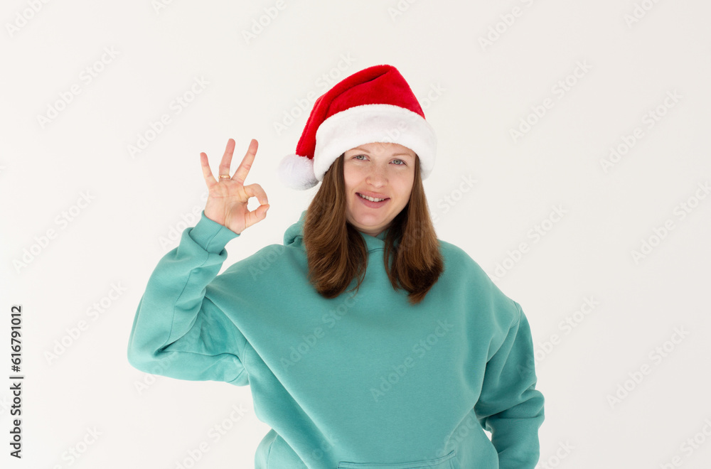 Close up photo of charming pregnant lady showing ok sign recommend event wearing green hoodie isolated over white background Close up photo of charming pregnant lady showing ok sign recommend event wearing green hoodie isolated over white background