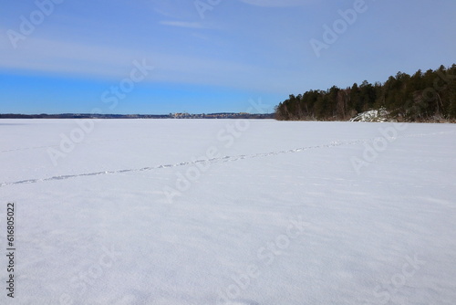 Frozen lake during the winter. Way of walking. Covered in snow and foot prints. Stockholm, Sweden, Scandinavia, Europe. © Martin of Sweden