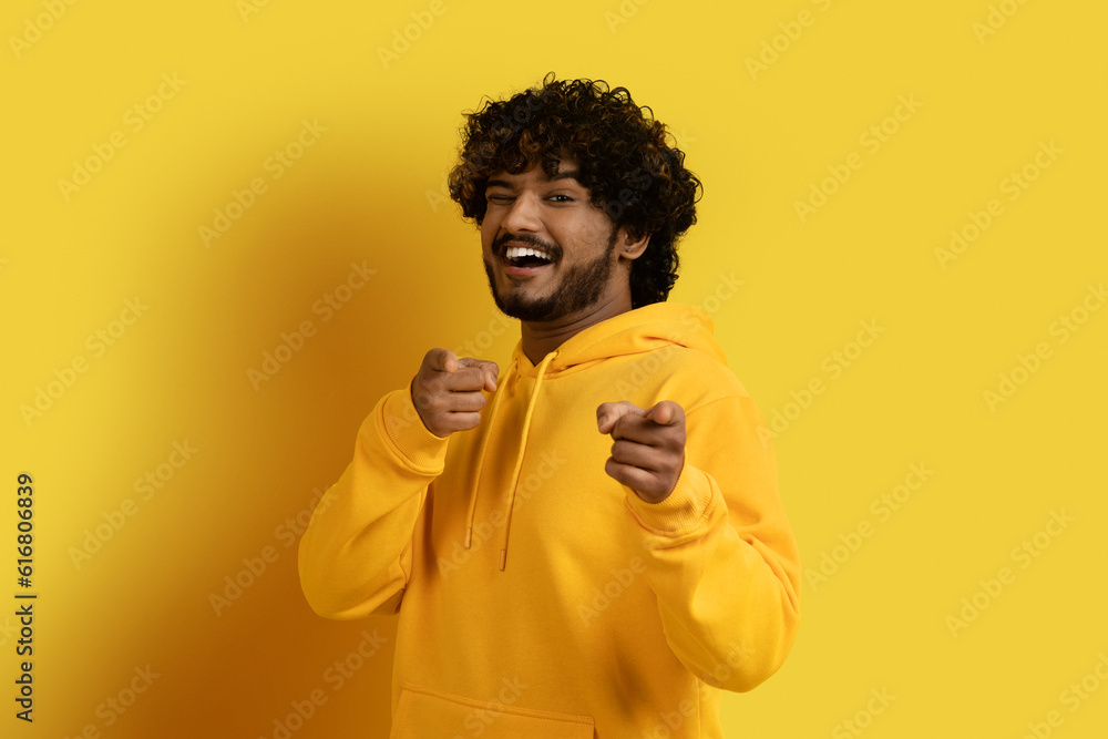 Cool handsome young eastern guy pointing at camera Cool handsome young eastern guy pointing at camera