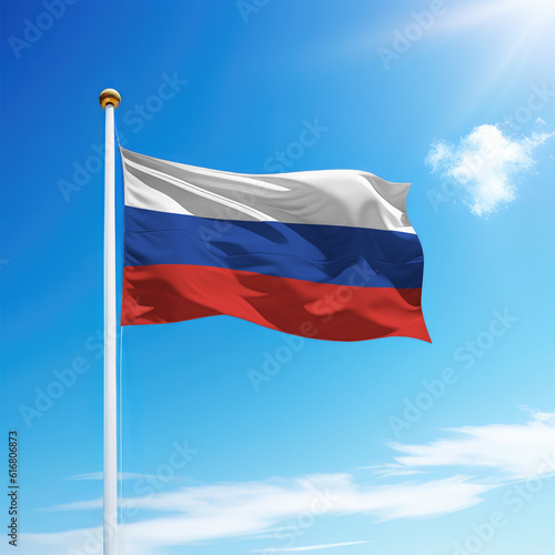 Waving flag of Russia on flagpole with sky background.