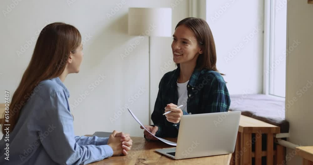 HR manager holds CV resume interviewing to female applicant, sit together at desk met in modern office. Recruiter listen to skilled job candidature, examining, ask questions. Human resources, staffing HR manager holds CV resume interviewing to female applicant, sit together at desk met in modern office. Recruiter listen to skilled job candidature, examining, ask questions. Human resources, staffing