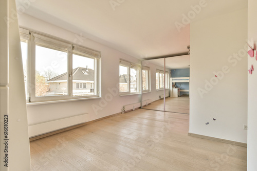 an empty living room with wood flooring and white walls in the room is very clean  but there is no furniture
