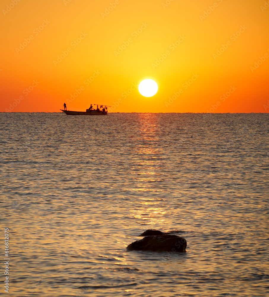 Silhouette of yachts and long-tail boat on the sea with golden sky and ...