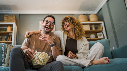 Couple caucasian man and woman sit at home on sofa bed watch tv movie