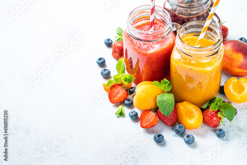 Smoothie set with fresh fruits and berries at white background.