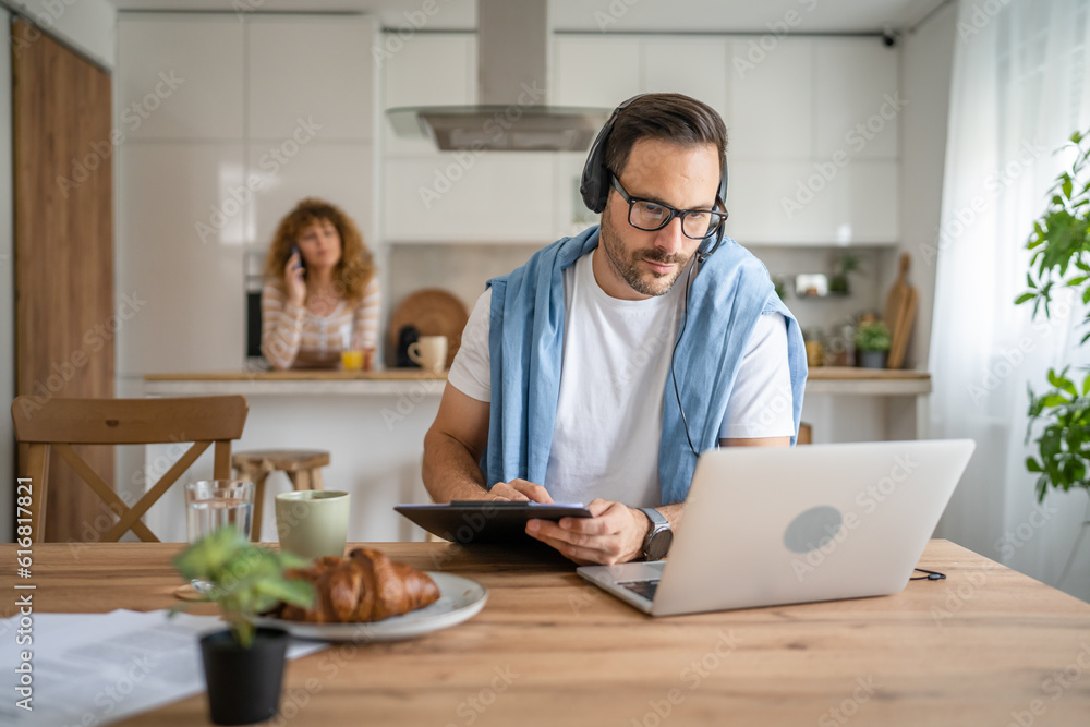 One man caucasian male freelancer work from home on laptop computer One man caucasian male freelancer work from home on laptop computer