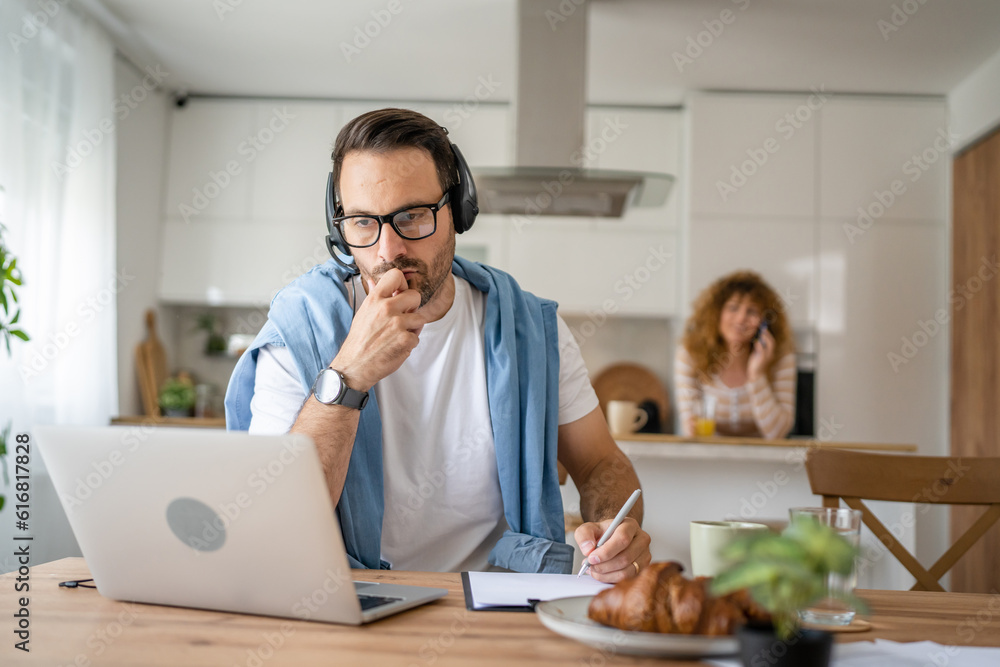 One man caucasian male freelancer work from home on laptop computer One man caucasian male freelancer work from home on laptop computer