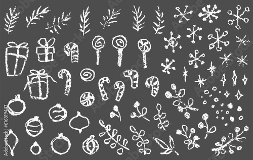 Chalk drawn Christmas set: snowflakes, gift boxes, candies, branches, spruce and bulbs. Vector hand drawn elements isolated on dark gray background. © Anna