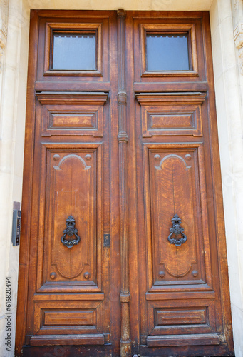 Old ornate door in Paris - typical old apartment buildiing.