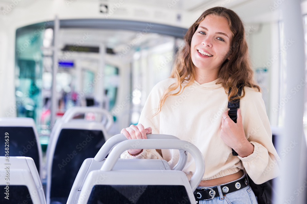 Portrait of stylish young female during her travel inside tram