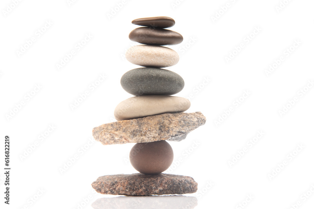 pyramid of stacked stones on a white background. stabilization and balance in life pyramid of stacked stones on a white background. stabilization and balance in life