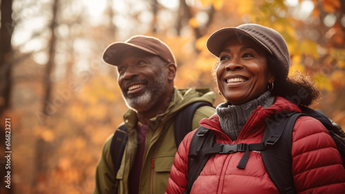 middle age couple smiling while hiking in the fall