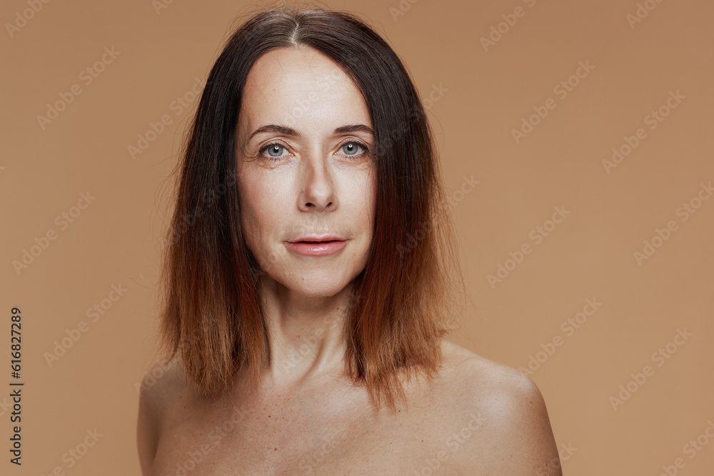 Portrait of modern female with short hair on beige background Portrait of modern female with short hair on beige background