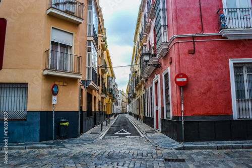 28.05.2023, Seville, Spain: Narrow streets of Seville with shops, cafes, restaurants and souvenir shops and colorful houses