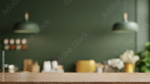 Wooden table top on blur kitchen room background,Modern Contemporary green kitchen room interior.