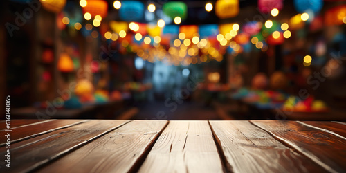 Empty wooden table with Mexican fiesta background out of focus photo