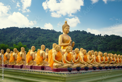 Big golden Buddha statue among small 1,250 Buddha statue at Makha Bucha Buddhist memorial park at nakhon nayok province, Thailand photo