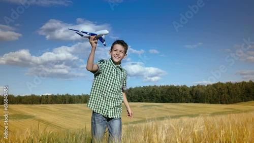Flight of Dreams: Joyful Boy Running through a Wheat Field with a Toy Airplane on a Sunny Summer Day