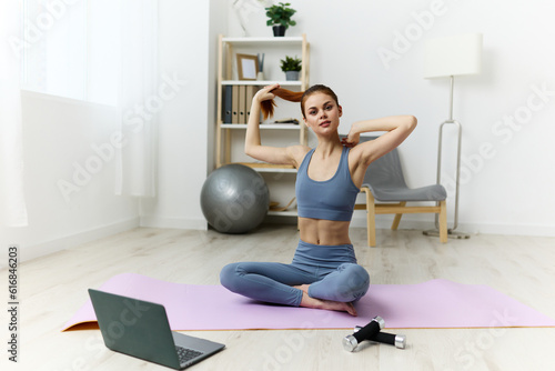 Fototapeta Naklejka Na Ścianę i Meble -  lifestyle woman training gym yoga lotus video health laptop mat home