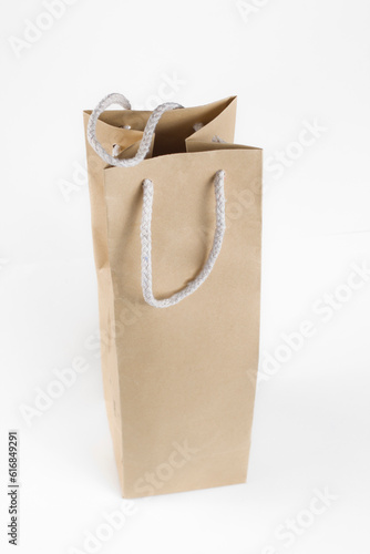 A brown paper bag with a white rope around it