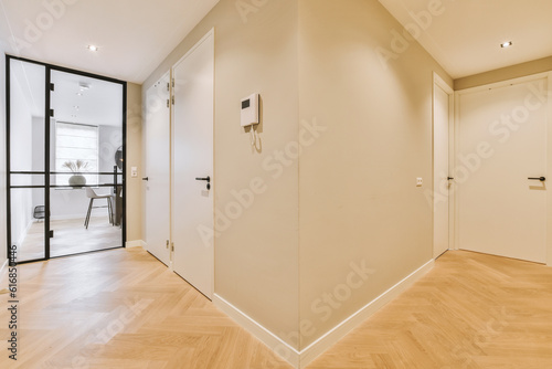 Wallpaper Mural an empty room with wood flooring and white walls on either side, there is a door in the corner Torontodigital.ca