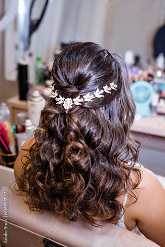 Hairstyle for a bride with a silver accessory in her hair