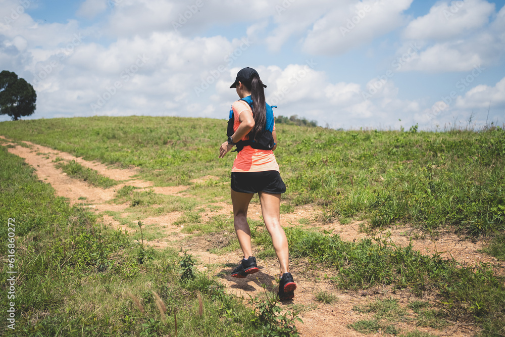 Young women active trail runners the top of a mountain in the afternoon, ultra marathon runners adventuring outdoors Young women active trail runners the top of a mountain in the afternoon, ultra marathon runners adventuring outdoors