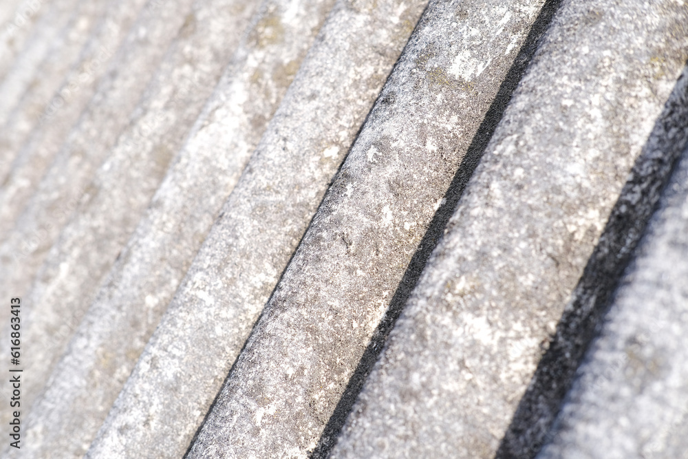 Close-up of shingles, slate roof. Abstract beige gray background with wavy texture. External design of the building. Roofing banner texture, background for roofing banner. Copy space, space for text