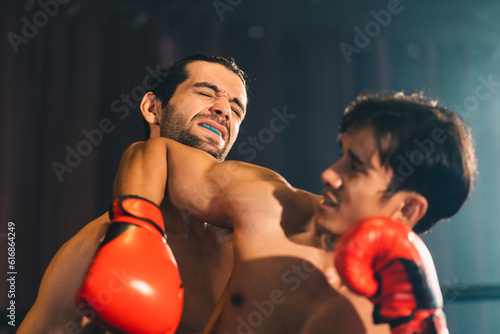 Gym atmosphere, Two professional fighters posing on the sport boxing ring. Fit muscular caucasian athletes or boxers fighting, Sport competition and human emotions concept, MMA or Thai Boxing match © chokniti