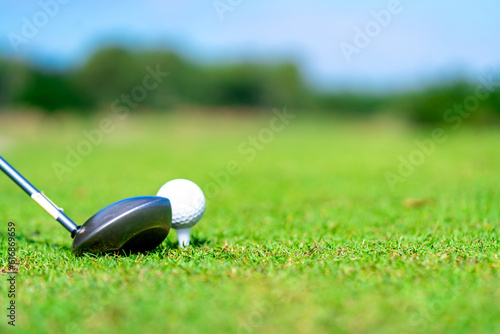 Confidence Asian man golfer holding golf club hitting golf ball on golf course fairway in sunny day. Healthy people enjoy outdoor activity lifestyle sport golfing at country club on summer vacation.