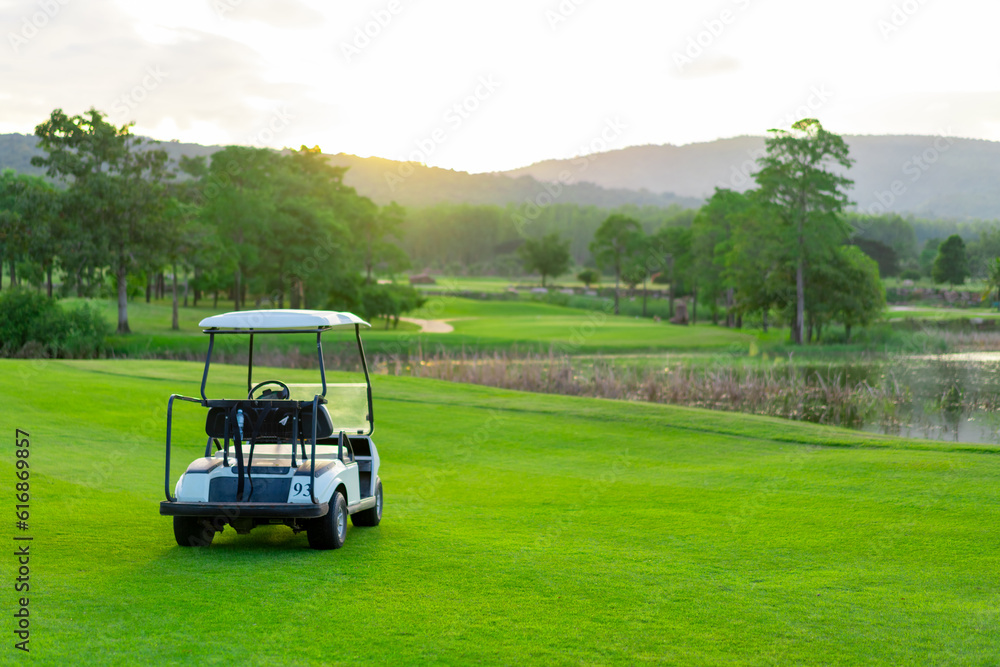 Golf cart on golf course at country club tourist resort. Healthy people golfer enjoy outdoor lifestyle leisure activity travel nature and play golf sport on summer holiday vacation.