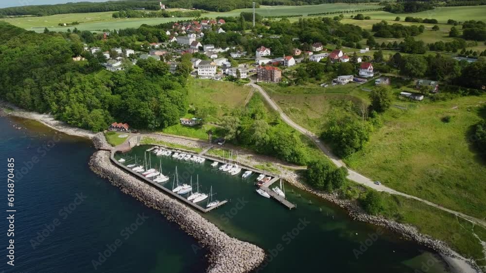 Incoming drone shot from the nice Lohme village with marina at the coast of the Rügen Island in Germany Incoming drone shot from the nice Lohme village with marina at the coast of the Rügen Island in Germany