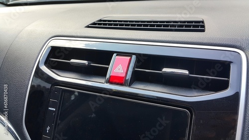 Car dasboard with AC vent, hazard light button and head unit display © fadfebrian