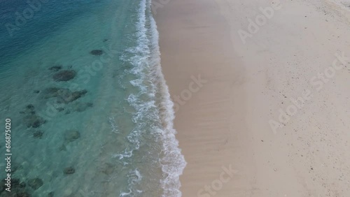 Flying above paradise beach with white sand and crystal clear water in Mentawais, Indonesia photo