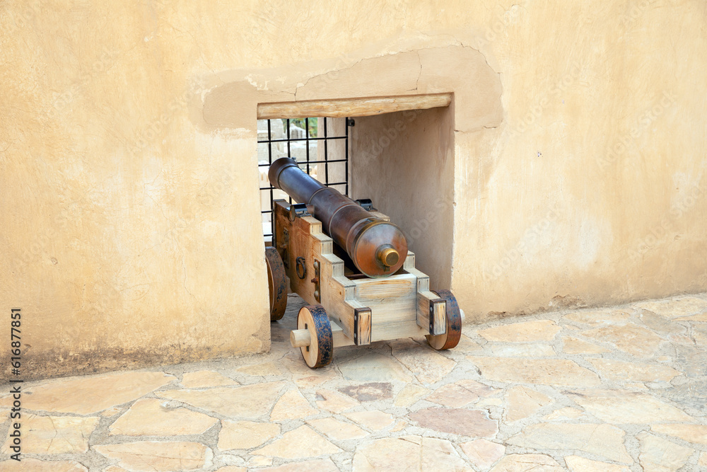 Ancient cannon in the loophole of Nizwa Fort. Sultanate of Oman