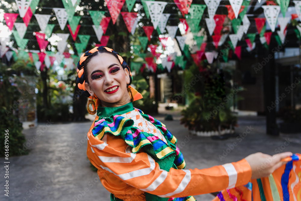 Obraz premium Latin woman dancer wearing traditional Mexican dress traditional from Guadalajara Jalisco Mexico Latin America, young hispanic female in independence day or cinco de mayo parade or cultural Festival